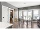 Stylish dining room with wood floors, glass table, and sliding barn door detail at 3484 Orchard St, Atlanta, GA 30354
