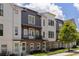 Townhome complex with brick facade, gray siding, charming balconies, and manicured lawn, bathed in sunlight at 3484 Orchard St, Atlanta, GA 30354