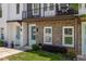 Eye-catching townhome showcasing a brick facade, quaint blue doors, and a charming second-story balcony at 3484 Orchard St, Atlanta, GA 30354