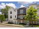 Townhome complex with brick facade, gray siding, charming balconies, and manicured lawn, bathed in sunlight at 3484 Orchard St, Atlanta, GA 30354