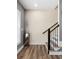 Hallway with wood floors, staircase and accent cabinet make a striking first impression at 3484 Orchard St, Atlanta, GA 30354