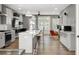 Spacious open kitchen with an island, pendant lights, stainless appliances and access to the living area at 3484 Orchard St, Atlanta, GA 30354
