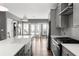 Modern kitchen with white countertops, stainless appliances, island with bar seating and gray cabinetry at 3484 Orchard St, Atlanta, GA 30354