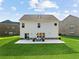 Exterior backyard showcasing a well-maintained lawn, white siding, and patio area, perfect for outdoor entertaining at 3962 Roberts Crest Dr, Suwanee, GA 30024