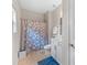 Bathroom with a shower/tub combo, tile floors, and white vanity at 3962 Roberts Crest Dr, Suwanee, GA 30024