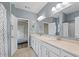 Bathroom with double sinks, white cabinets, and a neutral color scheme at 3962 Roberts Crest Dr, Suwanee, GA 30024