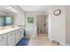 Bright bathroom featuring a walk-in shower and separate soaking tub under a window at 3962 Roberts Crest Dr, Suwanee, GA 30024