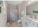 Bathroom with a shower/tub combo, tile floors, and white vanity at 3962 Roberts Crest Dr, Suwanee, GA 30024