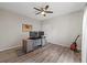 Office/bedroom with wood floors, ceiling fan, neutral walls, and bright natural light at 3962 Roberts Crest Dr, Suwanee, GA 30024