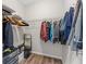 The closet has hanging clothes on metal racks and some storage underneath at 3962 Roberts Crest Dr, Suwanee, GA 30024