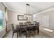 Elegant dining room featuring a modern chandelier, large mirror, and seating for eight people at 3962 Roberts Crest Dr, Suwanee, GA 30024