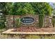 Stone entrance sign for Roberts Crest, adorned with shrubs and seasonal flowers at 3962 Roberts Crest Dr, Suwanee, GA 30024