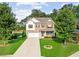 Inviting two-story home boasting a lush green lawn, complemented by mature trees and a welcoming facade at 3962 Roberts Crest Dr, Suwanee, GA 30024