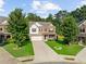 Beautiful two-story home featuring a manicured lawn, complemented by mature trees and a well-maintained exterior at 3962 Roberts Crest Dr, Suwanee, GA 30024