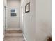 Hallway with wood floors, neutral walls, and white trim at 3962 Roberts Crest Dr, Suwanee, GA 30024