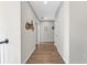 Hallway featuring wood floors, white walls, and decorative motorcycle wall art at 3962 Roberts Crest Dr, Suwanee, GA 30024
