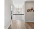 Bright hallway with light-colored walls and hardwood floors with a decorative motorcycle on the wall at 3962 Roberts Crest Dr, Suwanee, GA 30024