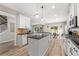 Bright kitchen features an island, granite countertops, stainless steel appliances, and wood floors at 3962 Roberts Crest Dr, Suwanee, GA 30024