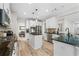 Modern kitchen featuring white cabinetry, stainless steel appliances, granite counters, and an island with seating at 3962 Roberts Crest Dr, Suwanee, GA 30024