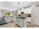 Bright kitchen features an island, granite countertops, stainless steel appliances, and wood floors at 3962 Roberts Crest Dr, Suwanee, GA 30024