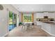 Bright kitchen with stainless appliances, and a cozy breakfast nook overlooking the backyard through sliding glass doors at 3962 Roberts Crest Dr, Suwanee, GA 30024