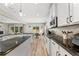 Bright kitchen featuring white cabinets, stainless appliances and a view of the outdoor living space at 3962 Roberts Crest Dr, Suwanee, GA 30024