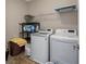 Laundry room featuring a washing machine and dryer with storage and shelving at 3962 Roberts Crest Dr, Suwanee, GA 30024
