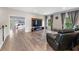 Cozy living room area with hardwood floors, TV, chair, and a glimpse into the bedroom at 3962 Roberts Crest Dr, Suwanee, GA 30024
