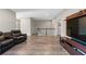 A spacious living room has hardwood floors, a black railing, seating, and a TV at 3962 Roberts Crest Dr, Suwanee, GA 30024