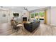 Bright and open living room area with a fireplace, large windows, and wood floors at 3962 Roberts Crest Dr, Suwanee, GA 30024