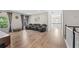 A spacious living room has hardwood floors, many windows, grey curtains, and seating area at 3962 Roberts Crest Dr, Suwanee, GA 30024