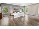 Bright main bedroom with hardwood floors, recessed lights, large windows, and artwork at 3962 Roberts Crest Dr, Suwanee, GA 30024