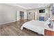 Hardwood floors and white bedding provide a clean look in this main bedroom at 3962 Roberts Crest Dr, Suwanee, GA 30024