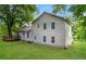 Backyard view of a two-story home with a wooden deck and spacious lawn surrounded by trees at 6194 Golden Meadow Court Ct, Riverdale, GA 30296