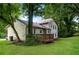 Backyard view of a two-story home featuring a wooden deck and spacious lawn with mature trees at 6194 Golden Meadow Court Ct, Riverdale, GA 30296