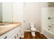 Bathroom with a vanity, toilet, shower and tub combination and wood look flooring at 6194 Golden Meadow Court Ct, Riverdale, GA 30296