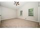Spacious bedroom with ceiling fan and two large windows for natural light at 6194 Golden Meadow Court Ct, Riverdale, GA 30296