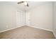 Cozy bedroom with neutral carpet, a ceiling fan, and closet at 6194 Golden Meadow Court Ct, Riverdale, GA 30296