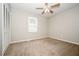 Bedroom with carpet, a ceiling fan, a window, and a closet at 6194 Golden Meadow Court Ct, Riverdale, GA 30296