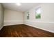 Spacious bedroom with hardwood flooring, neutral walls, base trim and natural light from the large windows at 6194 Golden Meadow Court Ct, Riverdale, GA 30296