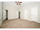 Spacious bedroom with neutral carpet and several doors at 6194 Golden Meadow Court Ct, Riverdale, GA 30296