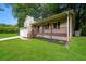 Inviting two-story home with a cozy front porch, well-kept lawn, attached garage and mature trees at 6194 Golden Meadow Court Ct, Riverdale, GA 30296