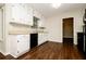 Bright kitchen featuring white cabinetry, laminate countertops, and modern black appliances at 6194 Golden Meadow Court Ct, Riverdale, GA 30296