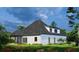 Beautiful white brick home with a covered back porch and well-manicured landscaping at 1077 Crooked Creek Rd, Lithonia, GA 30058