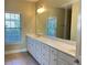 Bathroom with a double sink vanity, ample counter space, and natural light at 120 Chastain Nw Rd # 1803, Kennesaw, GA 30144