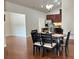 Dining area with hardwood floors and modern chandelier adjacent to kitchen at 120 Chastain Nw Rd # 1803, Kennesaw, GA 30144