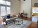 Bright and airy living room featuring a vaulted ceiling and hardwood floors at 120 Chastain Nw Rd # 1803, Kennesaw, GA 30144