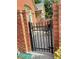 Enclosed patio with brick surround and an elegant wrought iron gate at 120 Chastain Nw Rd # 1803, Kennesaw, GA 30144