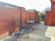 Cozy patio seating area with brick surround, table, and chairs at 120 Chastain Nw Rd # 1803, Kennesaw, GA 30144
