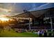 Outdoor amphitheater with lawn seating and a large stage under a modern, high-tech roof structure at 1438 Salem Dr, Alpharetta, GA 30009